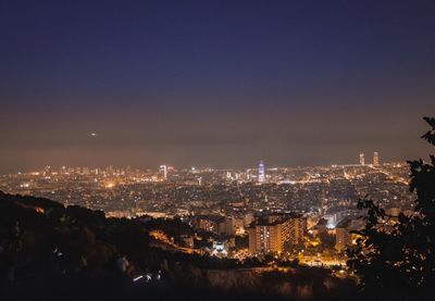 High angle view of city lit up at night