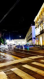 Illuminated city street at night