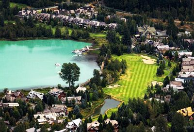 High angle view of lake by houses in town 