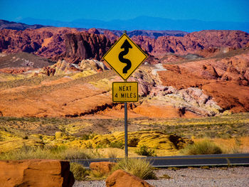 Information sign on rock against sky