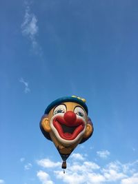 Low angle view of hot air balloon against blue sky