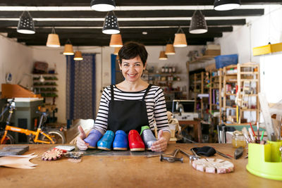 Portrait of confident clogmaker in her workshop