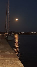 Sailboat on sea against clear sky at night