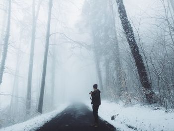 People standing on snow covered landscape