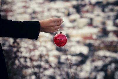 Cropped image of hand holding christmas ornament