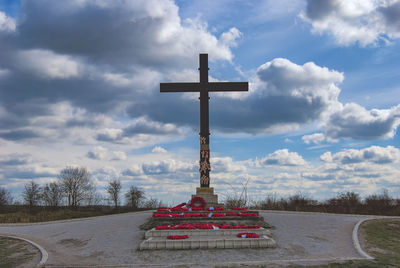 Cross sculpture against sky