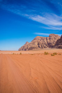 Scenic view of desert against blue sky