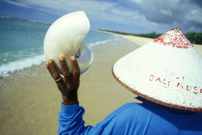 Low section of woman holding umbrella