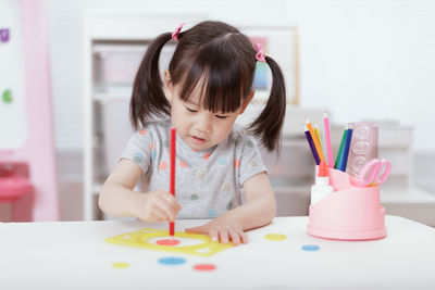 Young girl practice drawing different shapes for home schooling