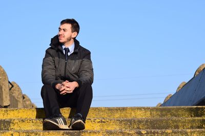 Full length of man in snowy field against clear sky