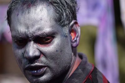 Close-up of man covered in powder paint during holi