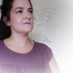 Portrait of beautiful woman standing against pink wall