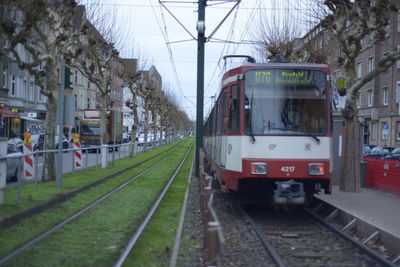 Train on railroad tracks in city