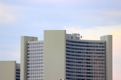 Low angle view of modern buildings in city against sky