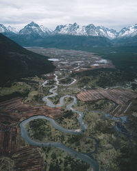 High angle view of snowcapped mountains against sky