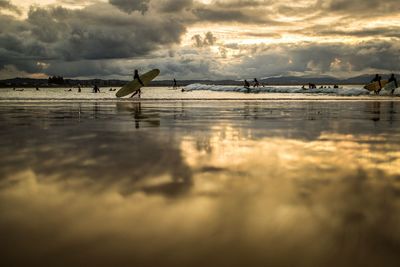 Clouds reflecting on beach during sunset