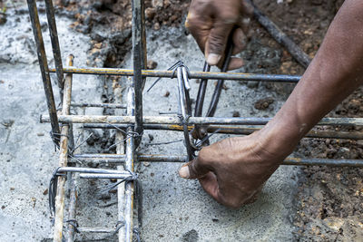 Close-up of man working on metal