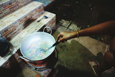 Midsection of person preparing food at kitchen