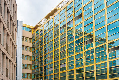 Low angle view of modern buildings against sky