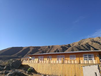 Built structure on mountain against blue sky