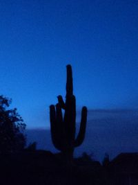 Silhouette people against clear sky at dusk