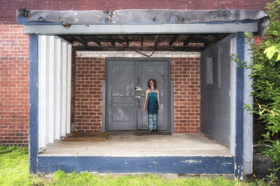 Woman standing in front of closed door