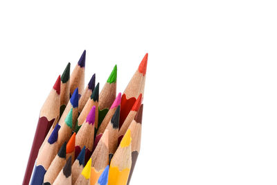 Close-up of colored pencils against white background