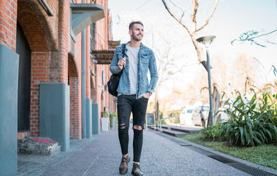 Portrait of young man standing in city