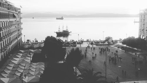 Rear view of people on sea against clear sky