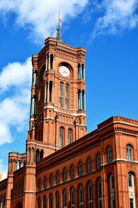 Low angle view of clock tower against blue sky