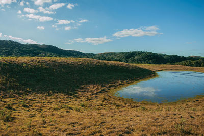 Landscape of rural lowlands called pampas with small lake and hills near cambara do sul, brazil.