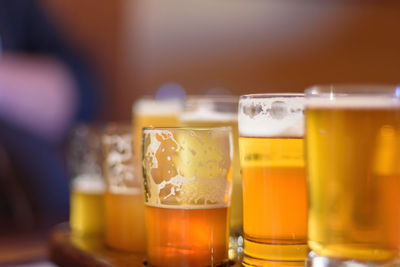 Close-up of beer glasses on table