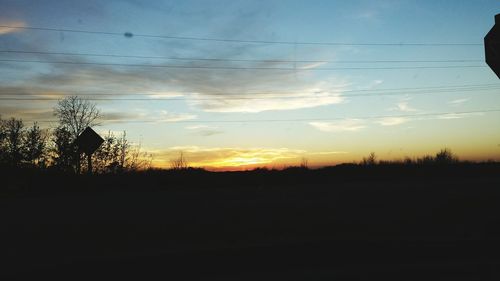 Silhouette trees against sky during sunset