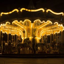 Illuminated ferris wheel at night