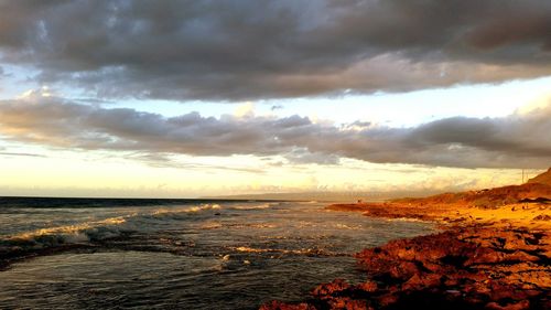 Scenic view of sea against cloudy sky