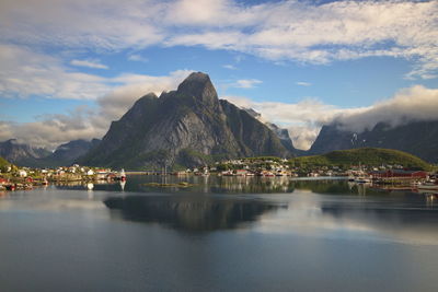 Scenic view of lake by buildings against sky