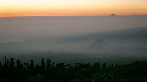 Scenic view of landscape against sky during sunset