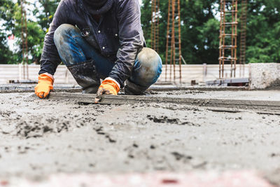 Low section of man working on street