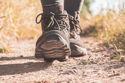 Low section of man wearing shoes