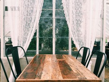 Chairs and table against window at home