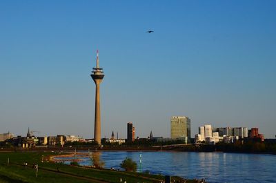 View of river and buildings against clear sky