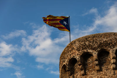 Low angle view of flag against sky