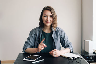 Young professional engaged in a video conference, communicating with confidence through a web camera