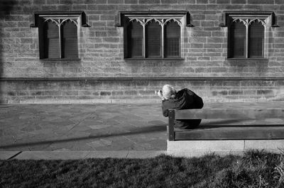 Full length of woman standing by building