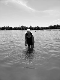 Full length of man in lake against sky