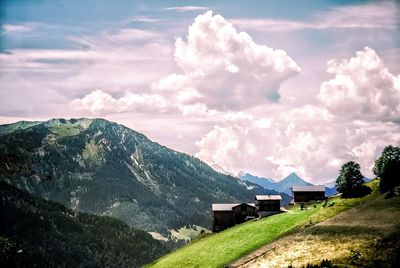 Scenic view of houses and mountains against sky