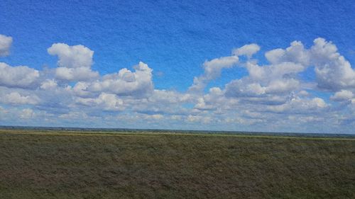 Scenic view of landscape against cloudy sky