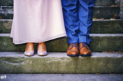 Low section of couple standing outdoors