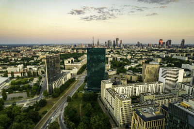 Warsaw, city centre panorama at sunset, business centre 2022. sunset reflected in buildings.