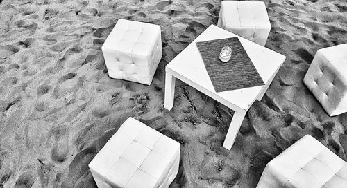 High angle view of papers on sand at beach